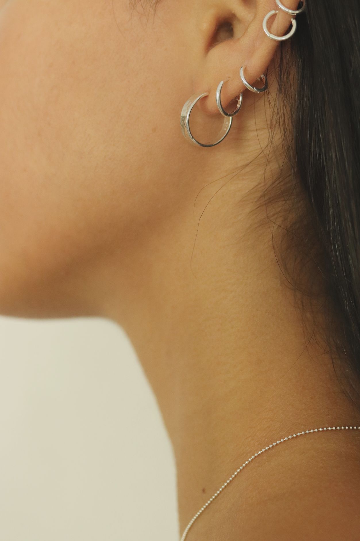 עגילי חישוק דקים בטקסטורה מרוקעת. פתוחים בחלקם האחורי ועשויים מכסף 925.jpg